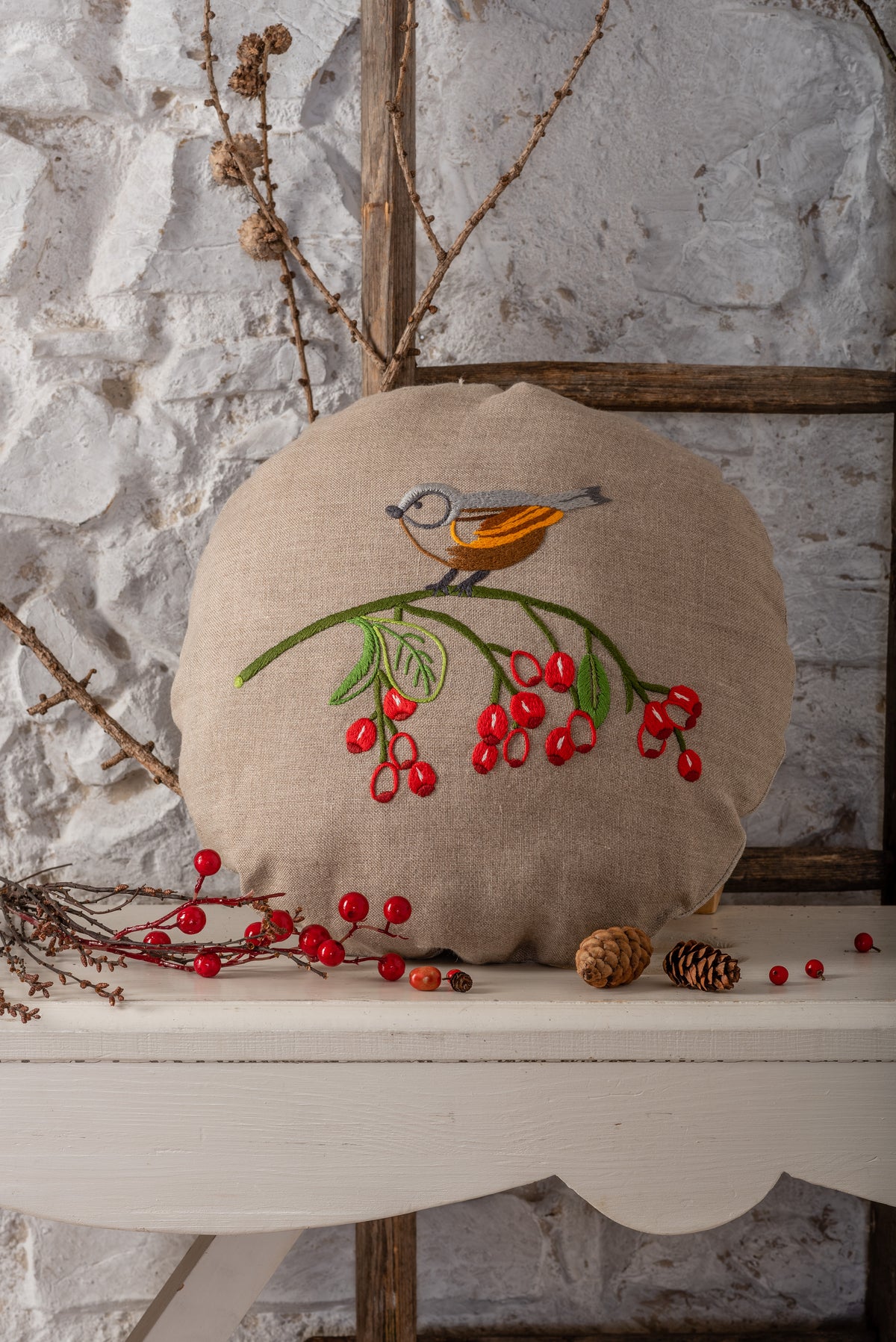 Round embroidered cushion with vintage bird design