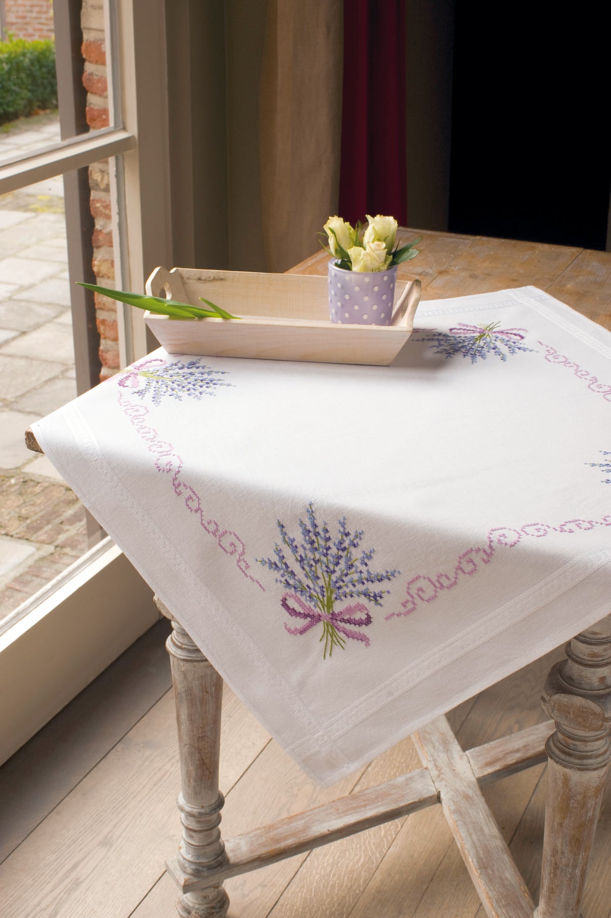 White cotton tablecloth stitched with a lavender design