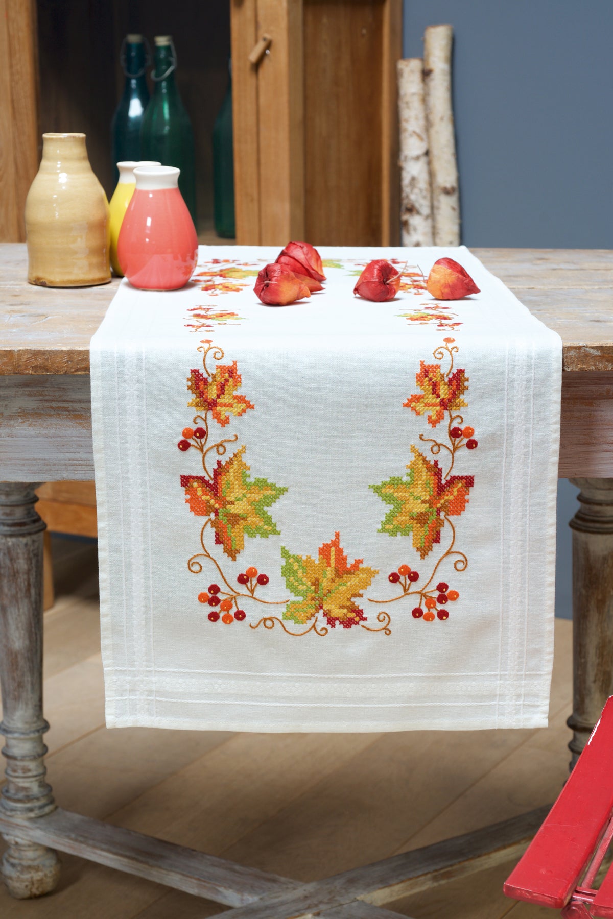 Ecru cotton table runner stitched with a autumn leaves design