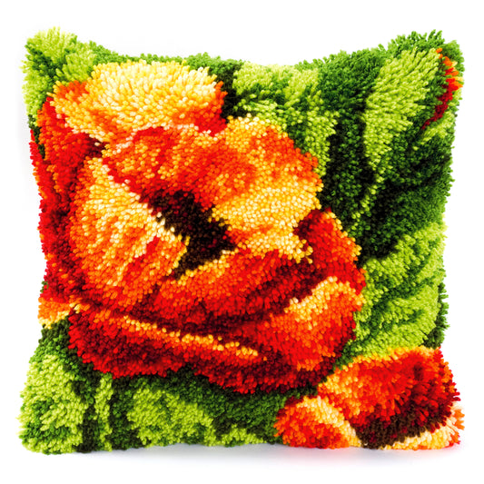 Latch hook cushion with a large orange poppy on green