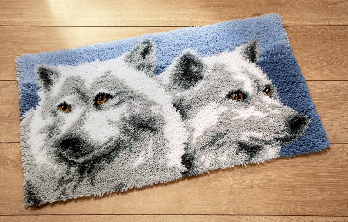 Finished Vervaco latch hook rug with a wolves design