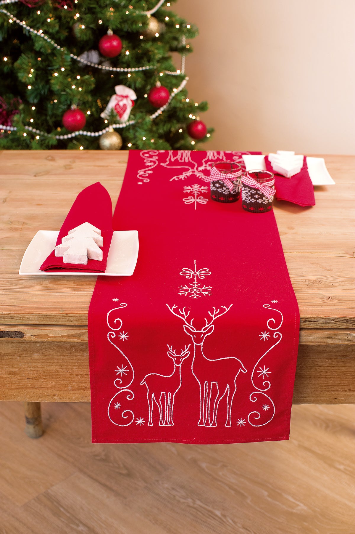 Embroidered table runner with deer and ice crystals design