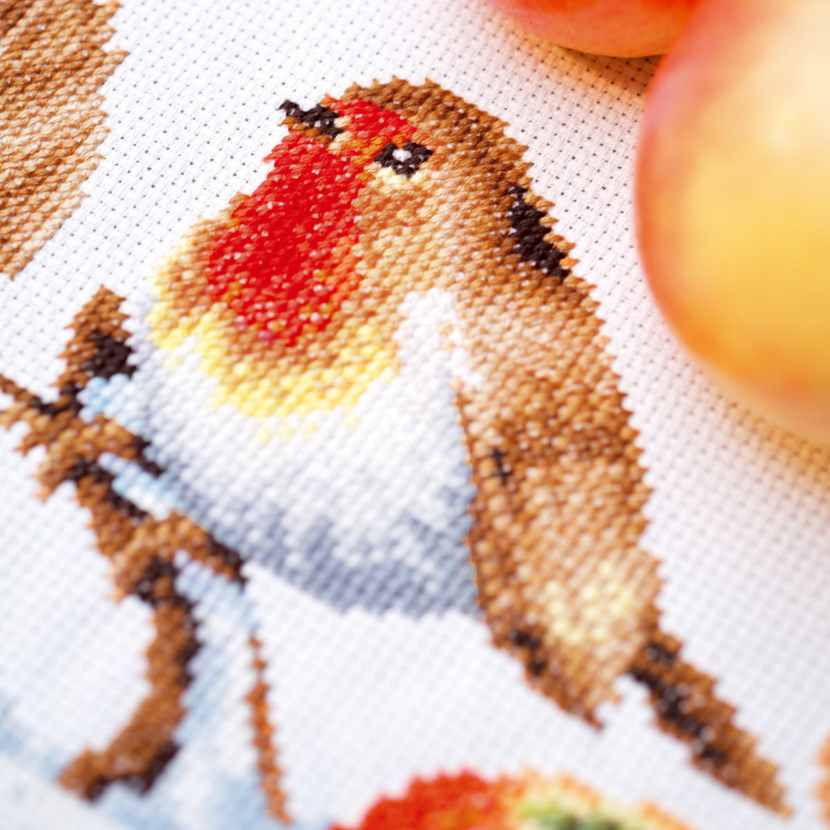 Cross stitched table runner with a robin design