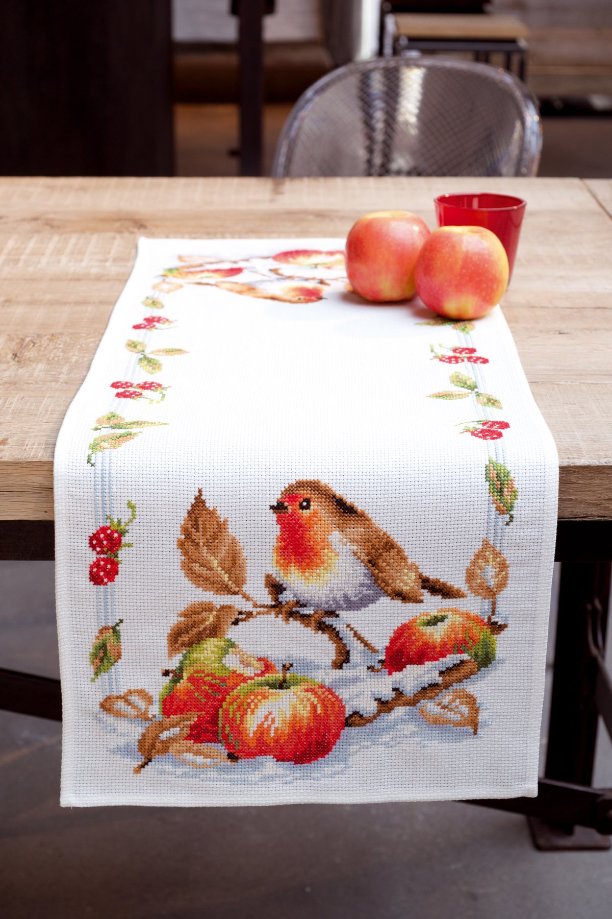 Cross stitched table runner with a robin design