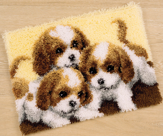 Latch hook rug showing three puppies