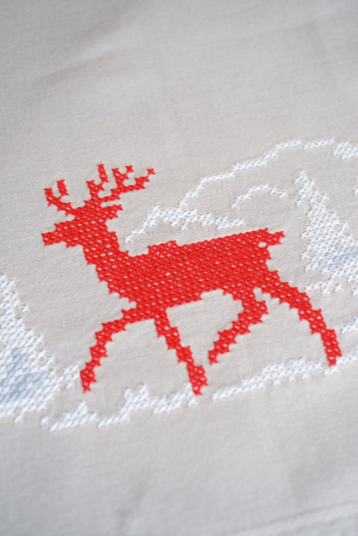 Square beige tablecloth with a Nordic winter cross stitch border design