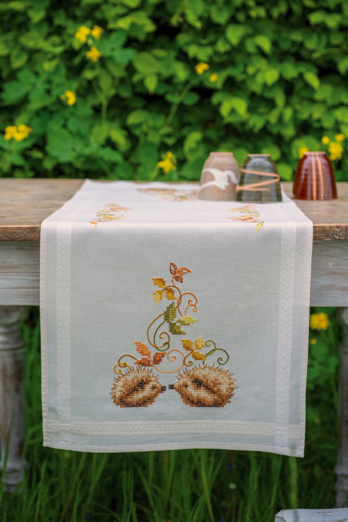Embroidered table runner with hedgehogs and autumn leaves