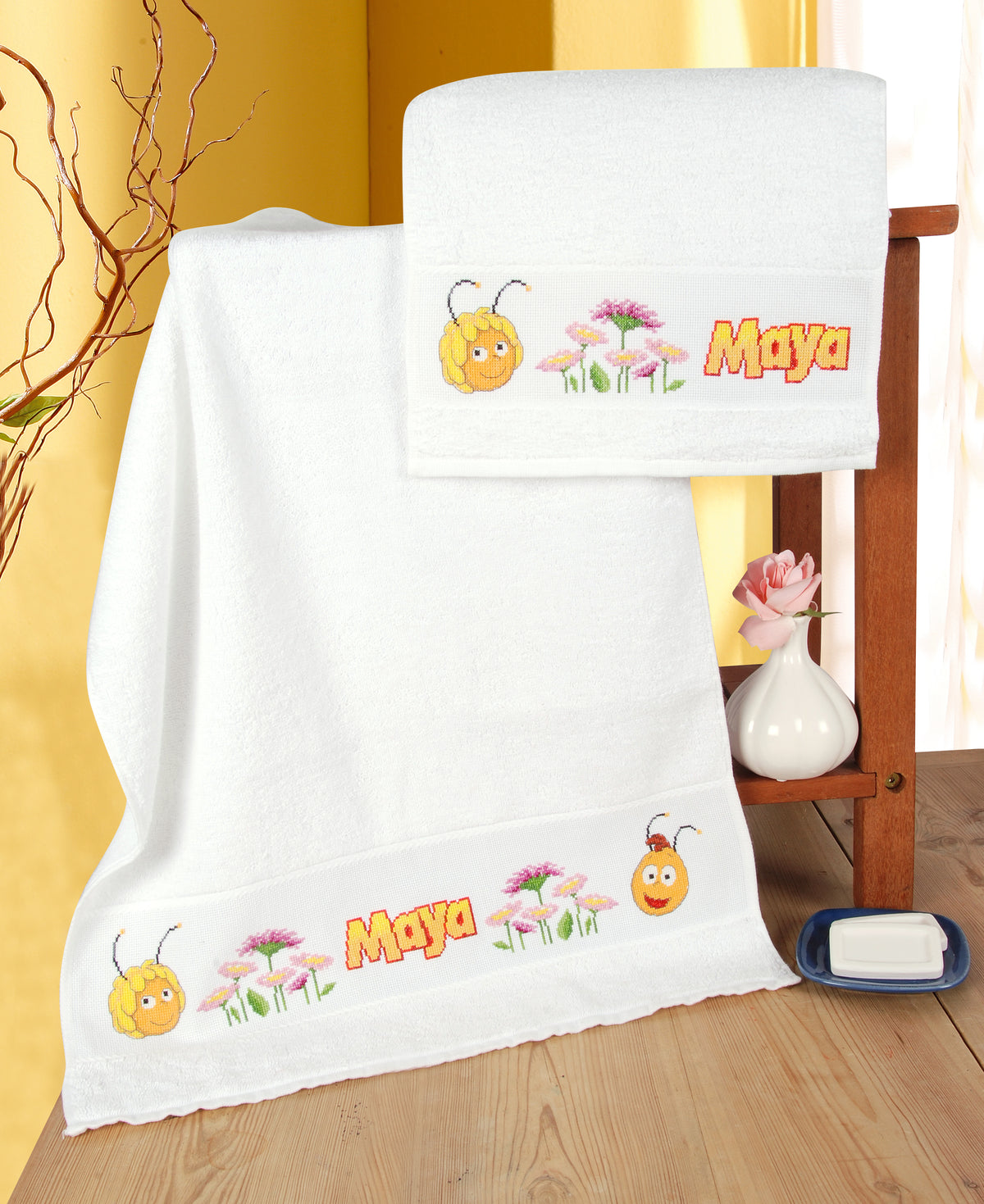 White towel with a cross stitched Maya the Bee and Willy border