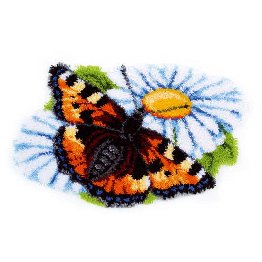 Shaped latch hook rug of a butterfly on a daisy