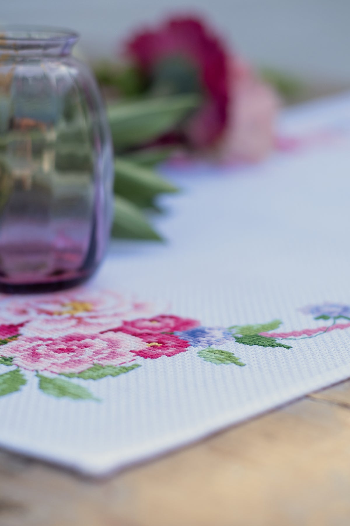 Cross stitched table runner with floral bouquets