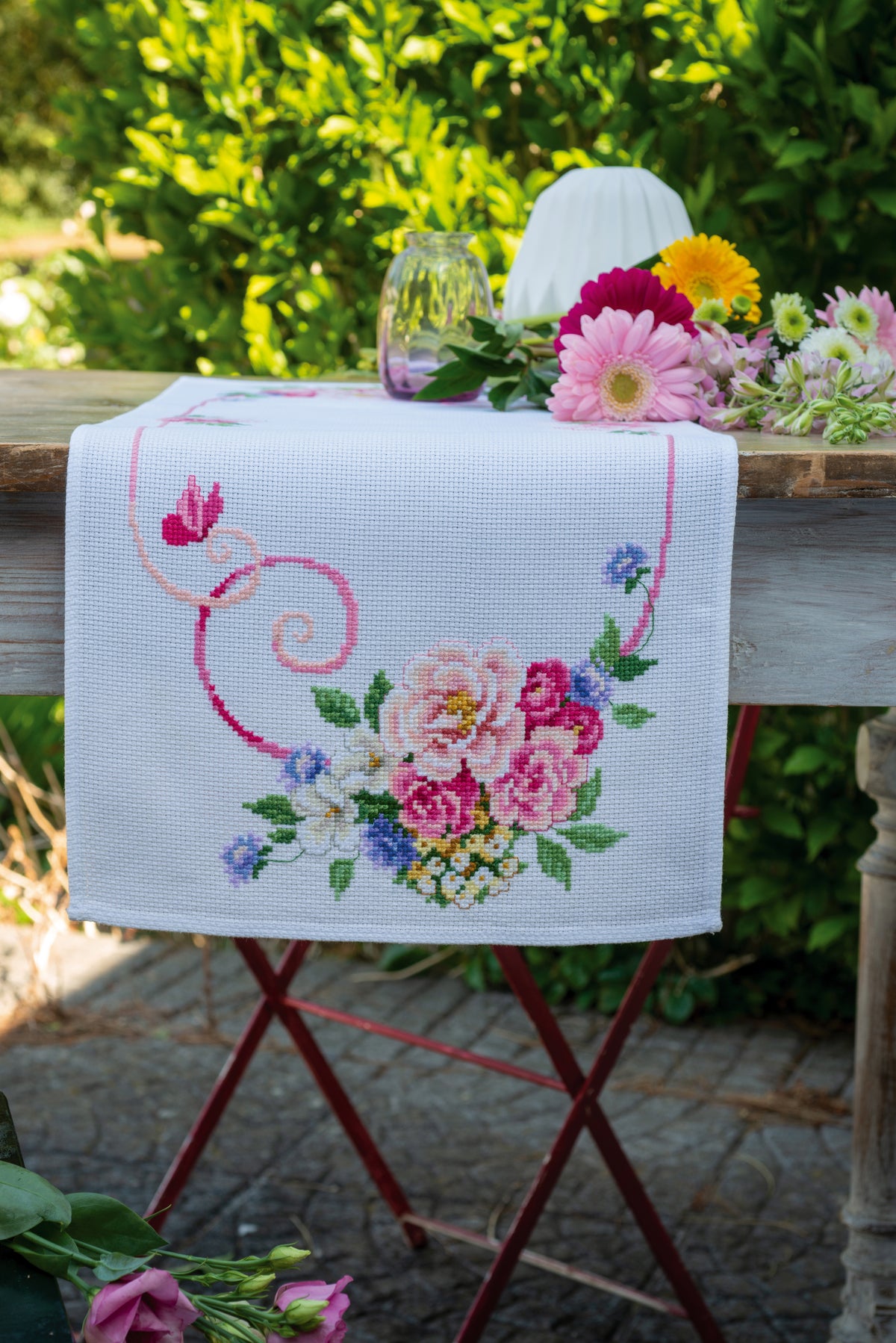 Cross stitched table runner with floral bouquets