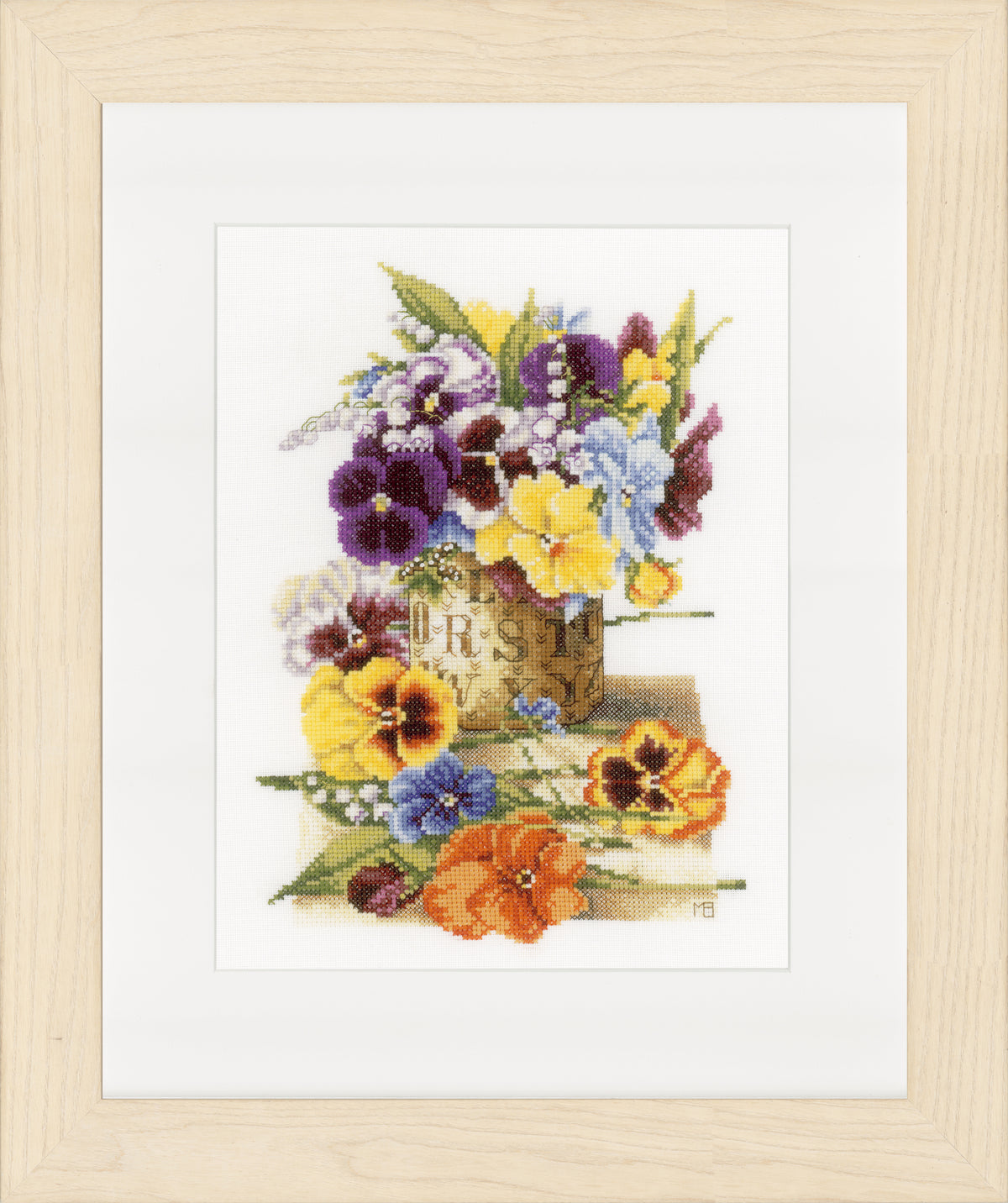 Framed cross stitch of pansies in a flower pot