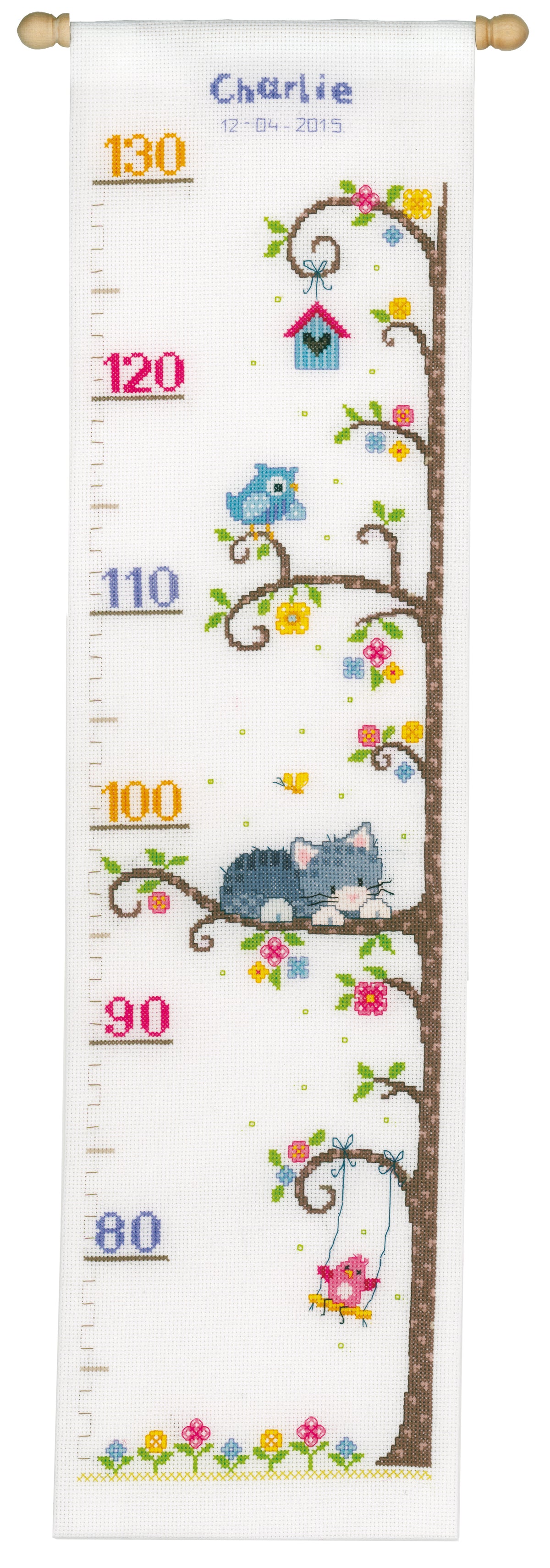 Cross stitched height chart with a cat in a tree