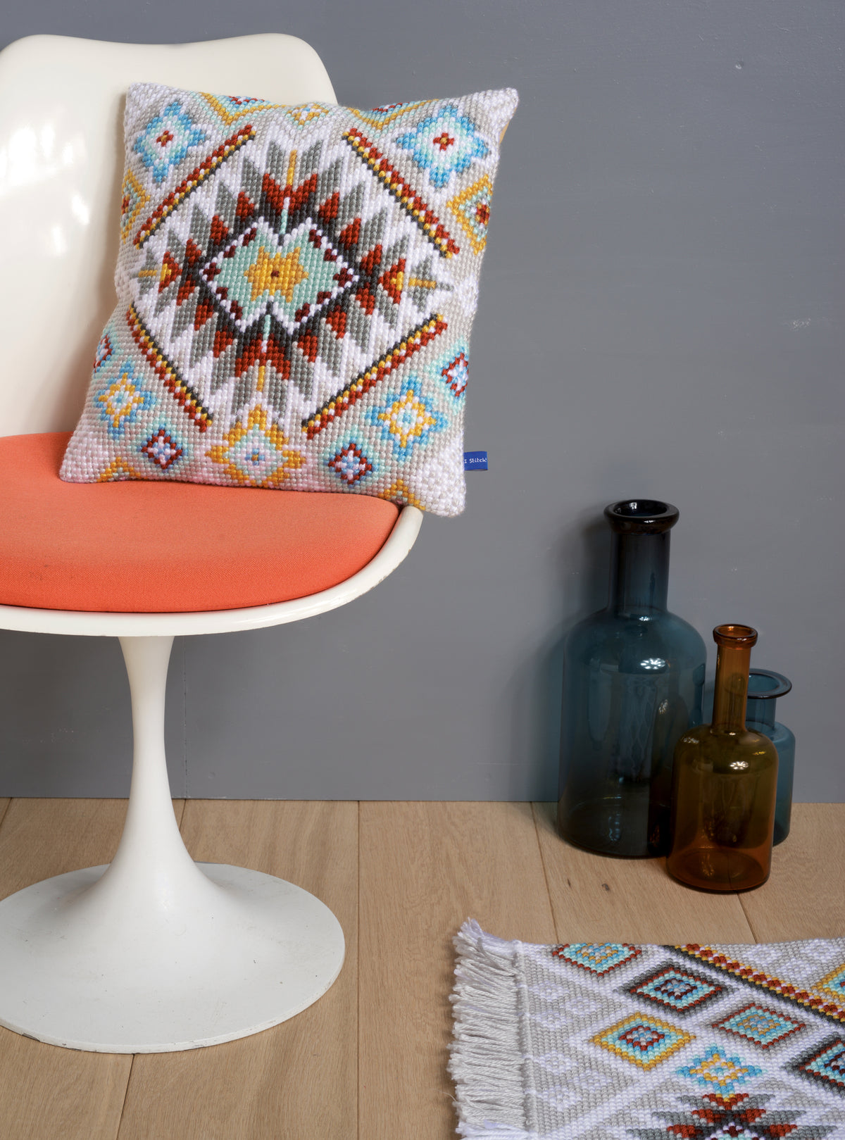 Cross stitch cushion with an ethnic pattern