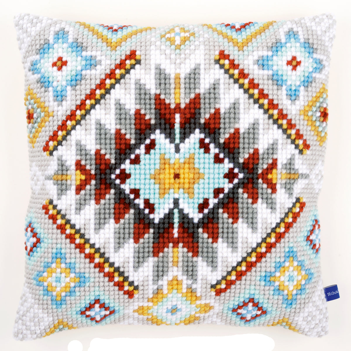 Cross stitch cushion with an ethnic pattern