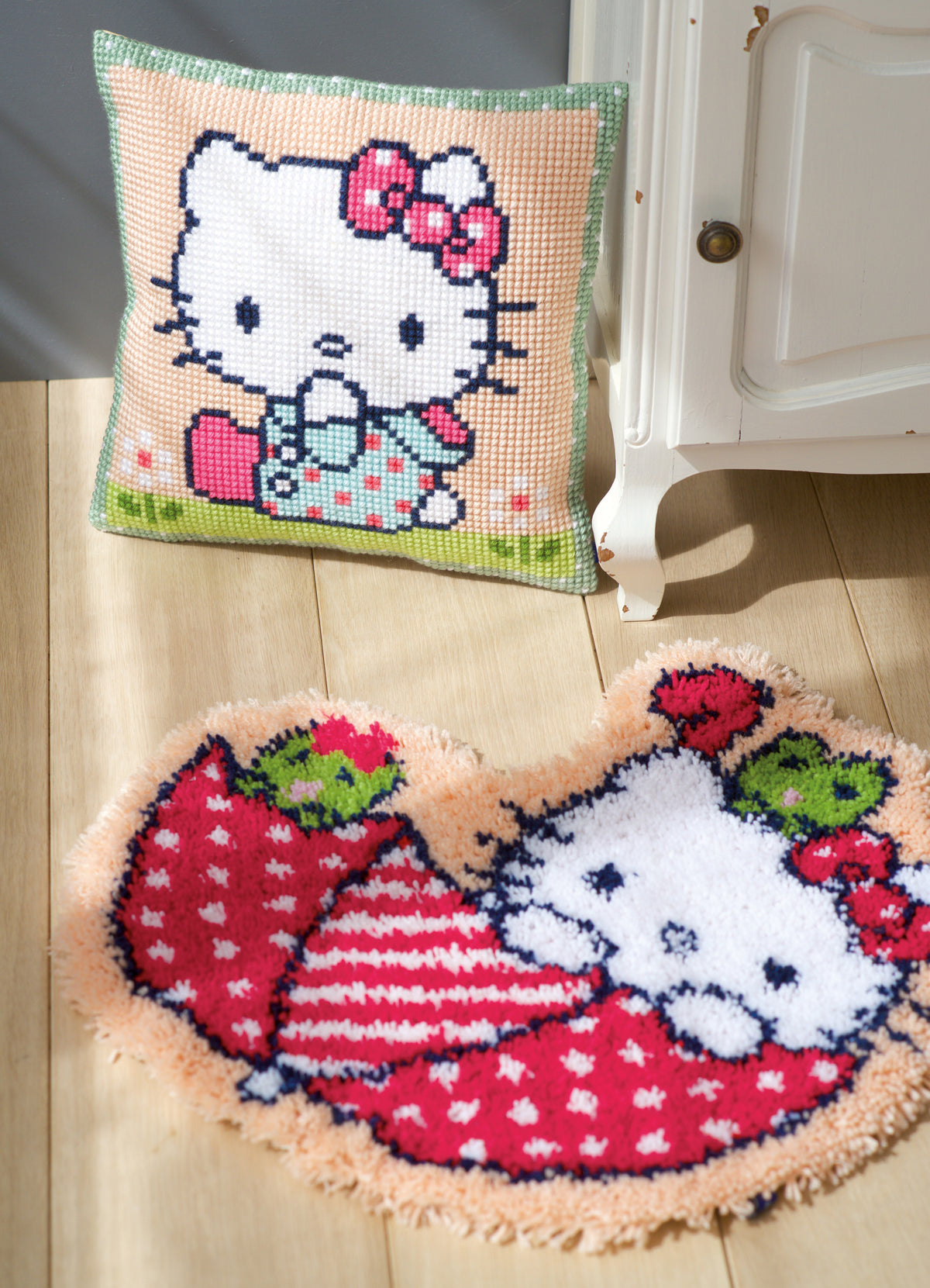 Hello Kitty cross stitch cushion with Kitty on a green lawn