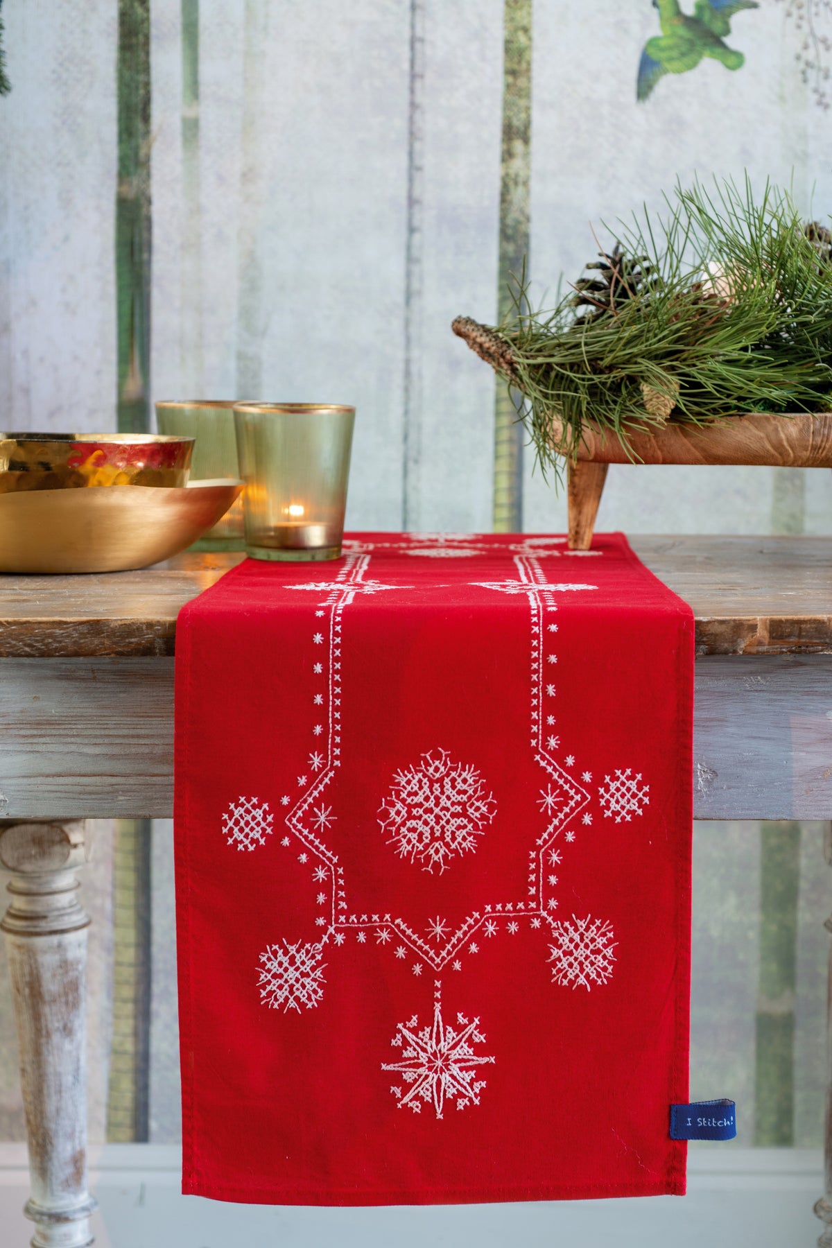 Red embroidered table runner with white Christmas stars