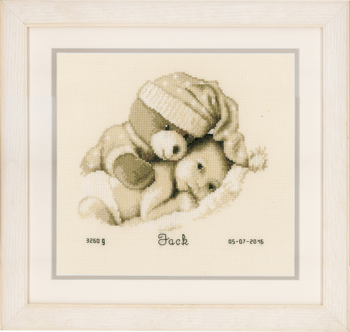 Cross stitch birth record with a baby and teddy bear