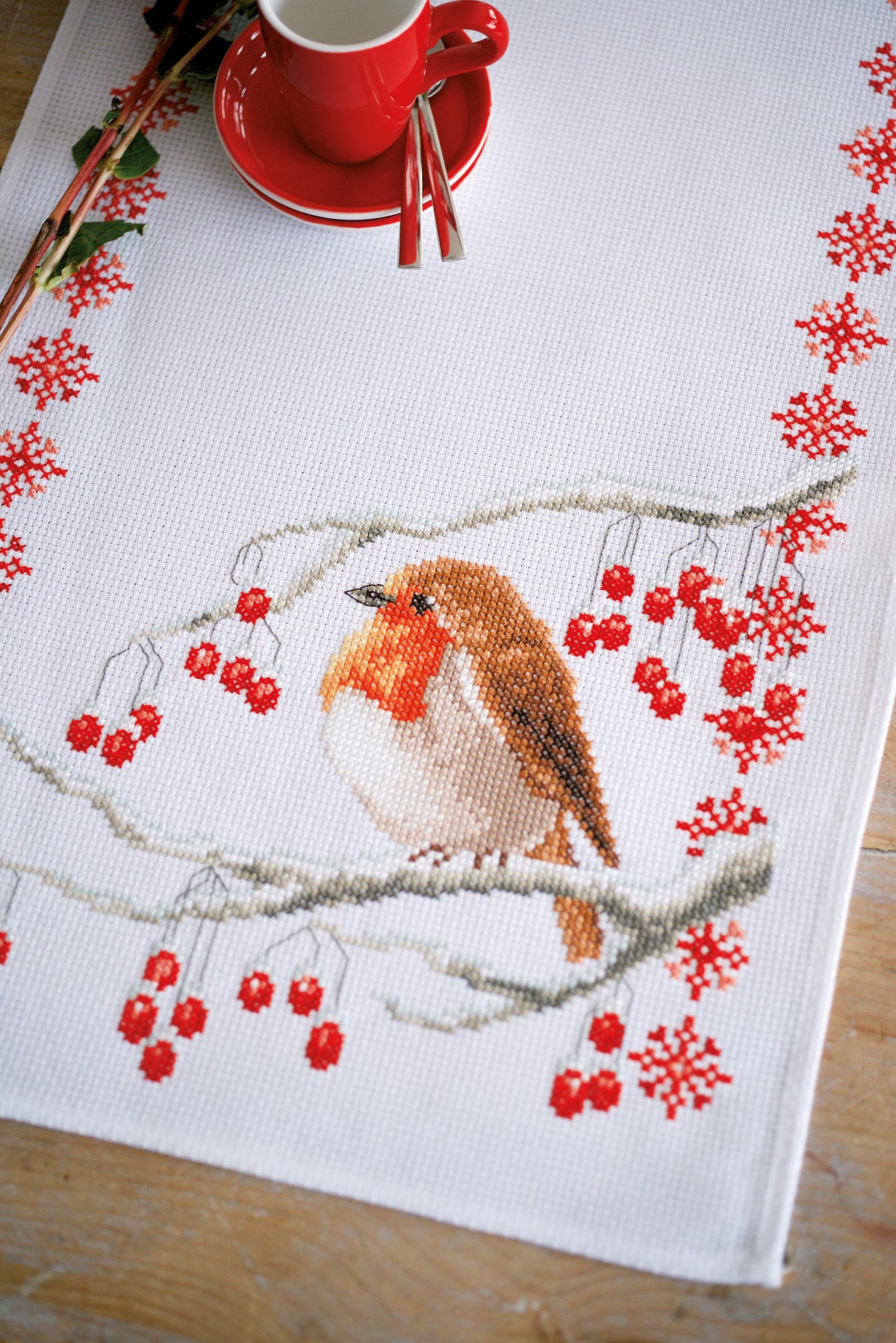Cross stitch table runner featuring robins on white aida