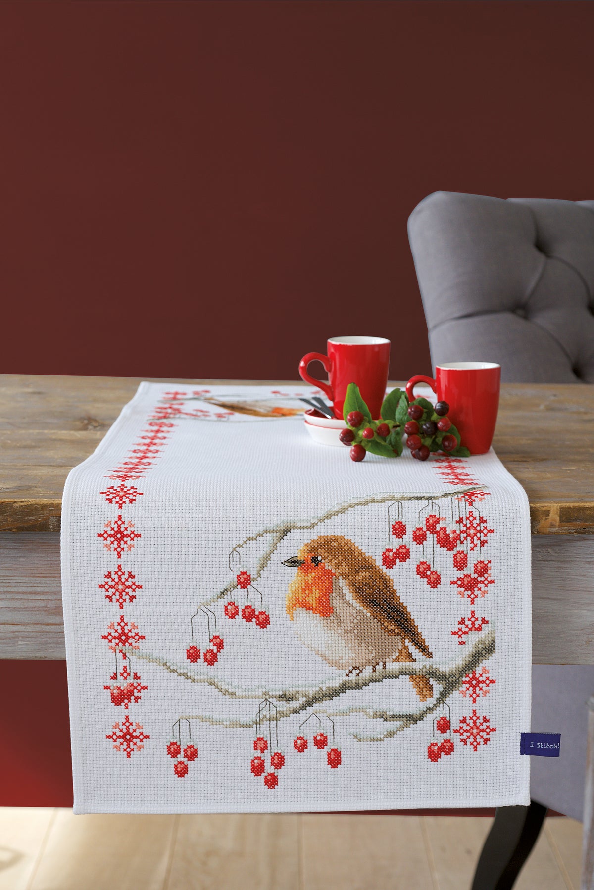 Cross stitch table runner featuring robins on white aida