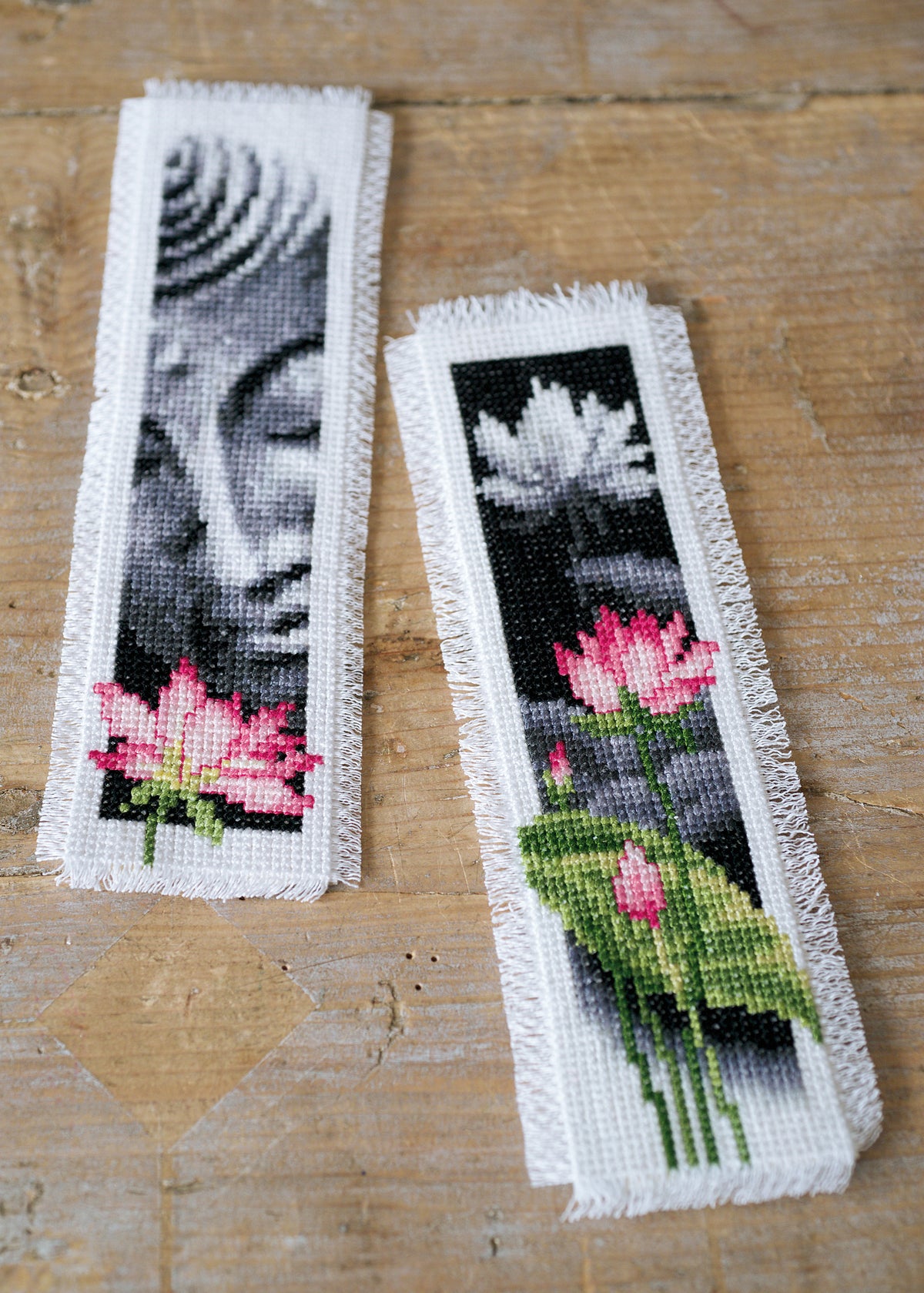 Two cross stitch bookmarks with lotus flower and Buddha designs