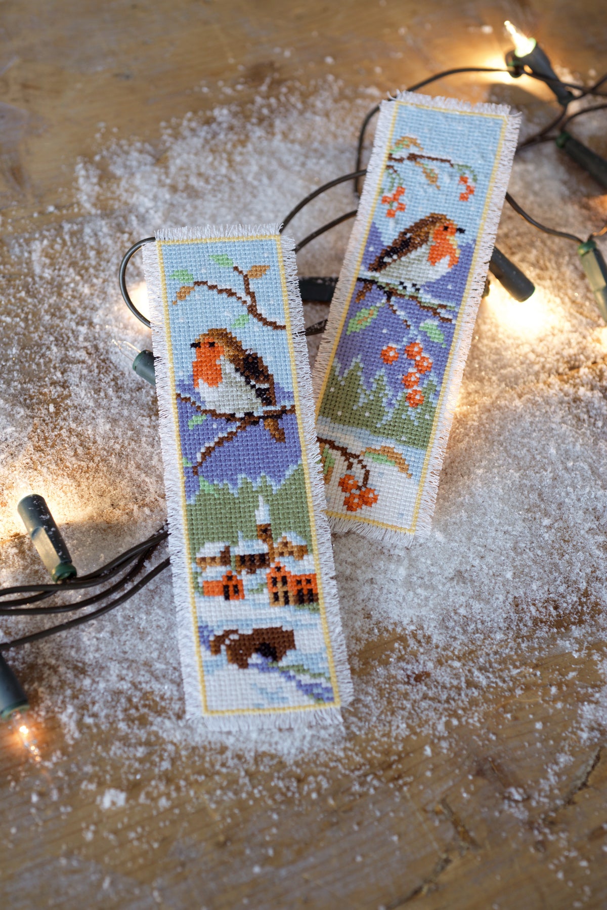 Two cross stitch bookmarks featuring robins