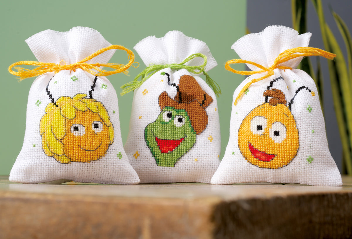 Three cross stitch gift bags featuring Maya, Willy and Flip