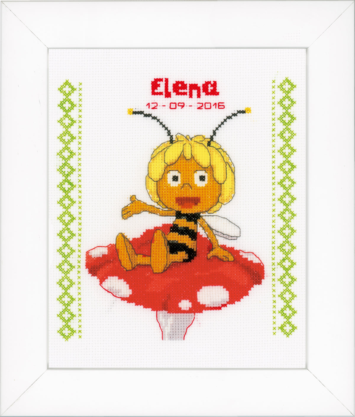 Cross stitch birth record with Maya sitting on a mushroom