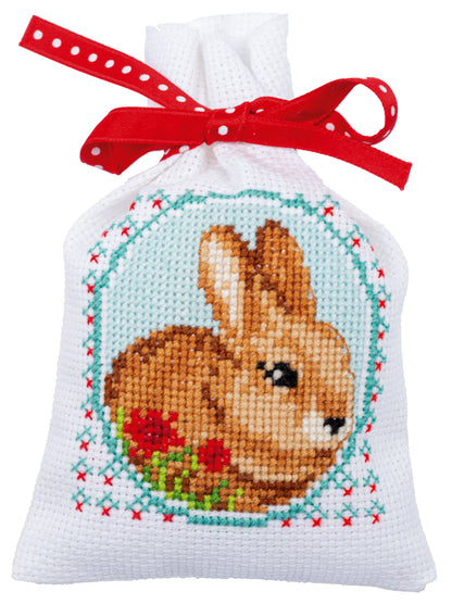 Three cross stitch gift bags with fairy tale designs