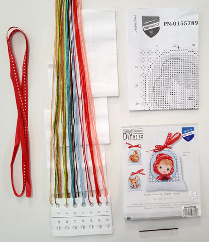 Three cross stitch gift bags with fairy tale designs