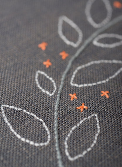 C'est La Vie embroidered cushion kit by Vervaco on dark grey fabric