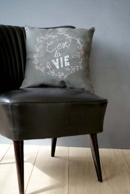 C'est La Vie embroidered cushion kit by Vervaco on dark grey fabric