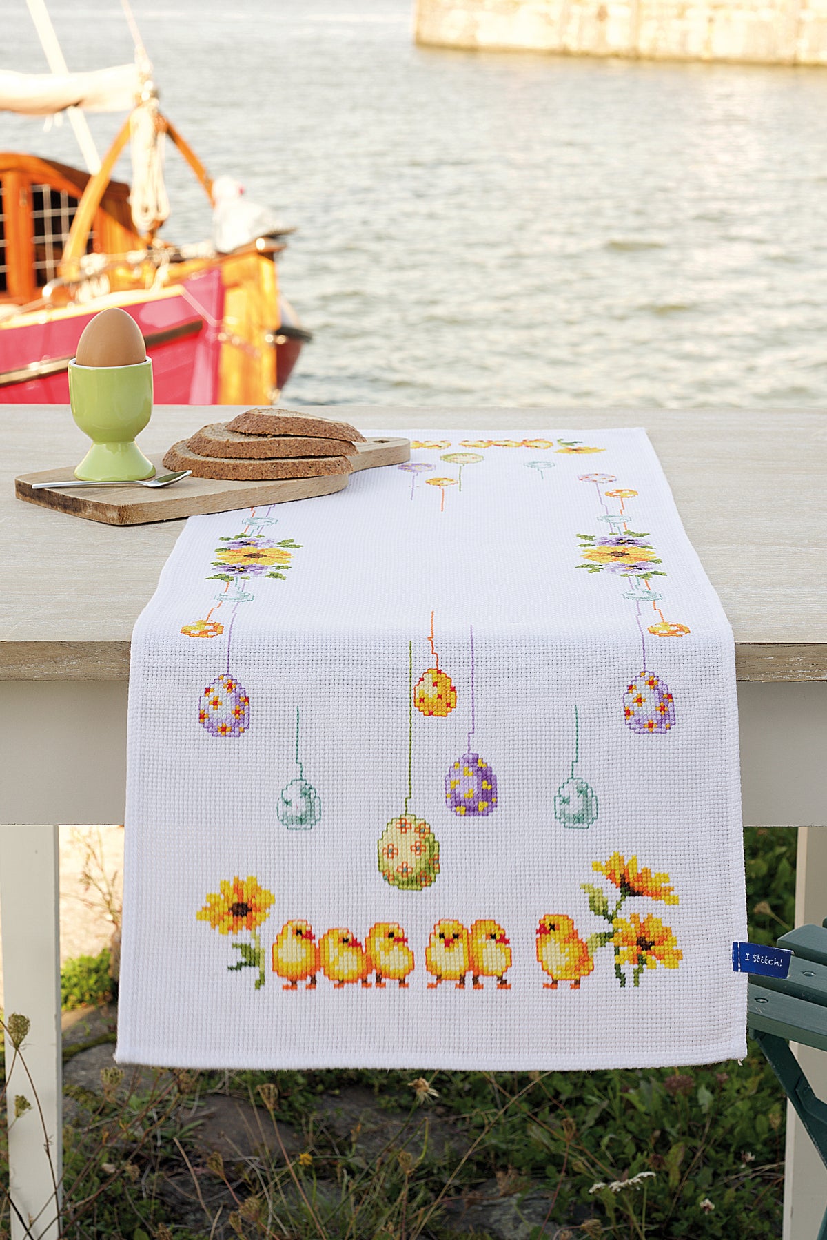Cross stitched table runner with chicks and eggs