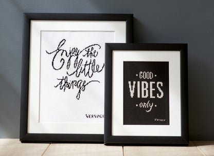 Cross stitched Good Vibes design on black fabric
