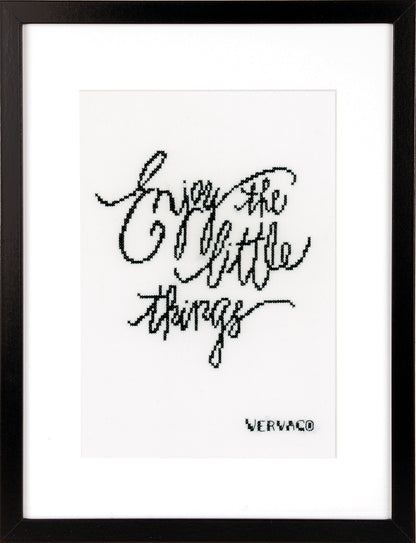 Cross stitched Enjoy the Little Things design on black fabric