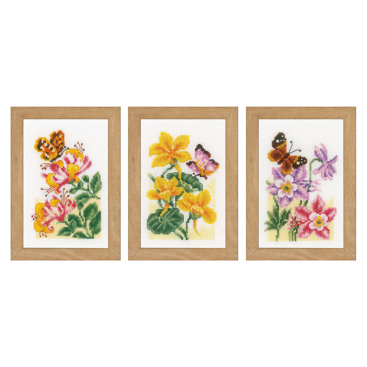 Three miniature cross stitched butterflies