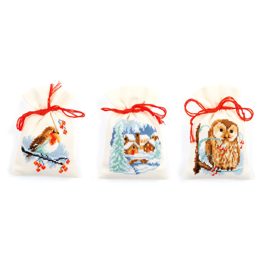 Three cross stitched winter gift bags