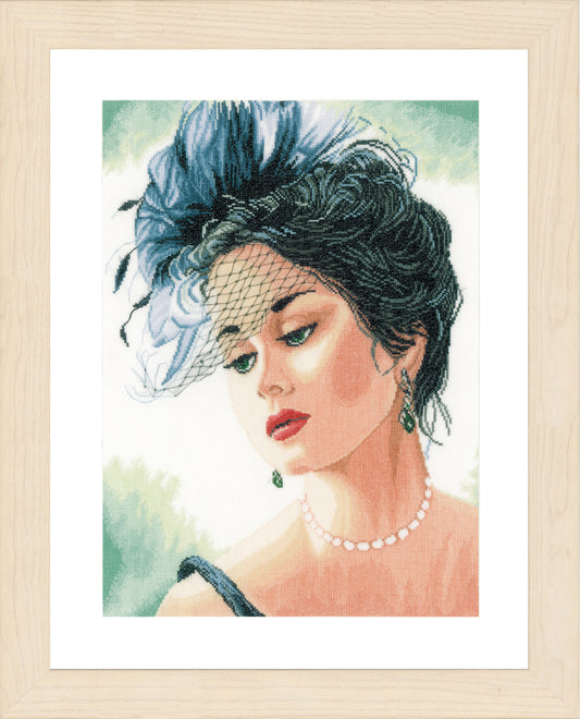 Cross stitch picture of a lady wearing a hat