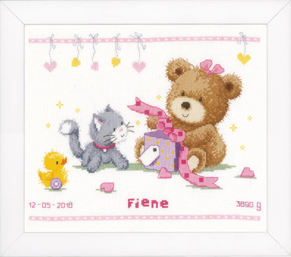 Cross stitch of a teddy bear with a present
