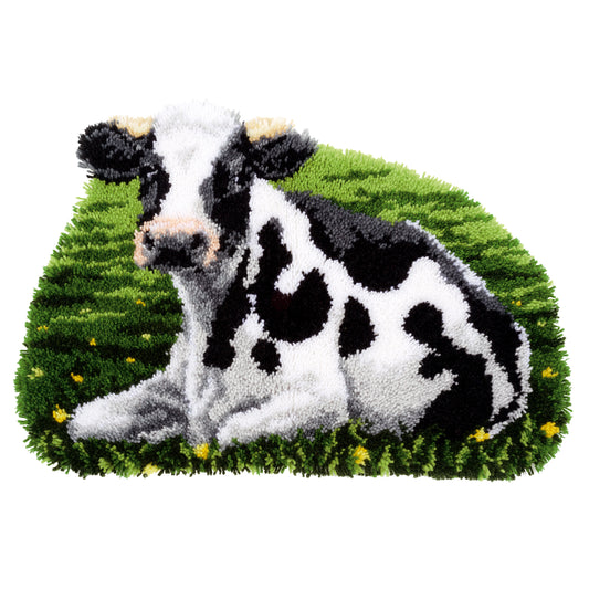 Cow-shaped latch hook rug of a resting cow