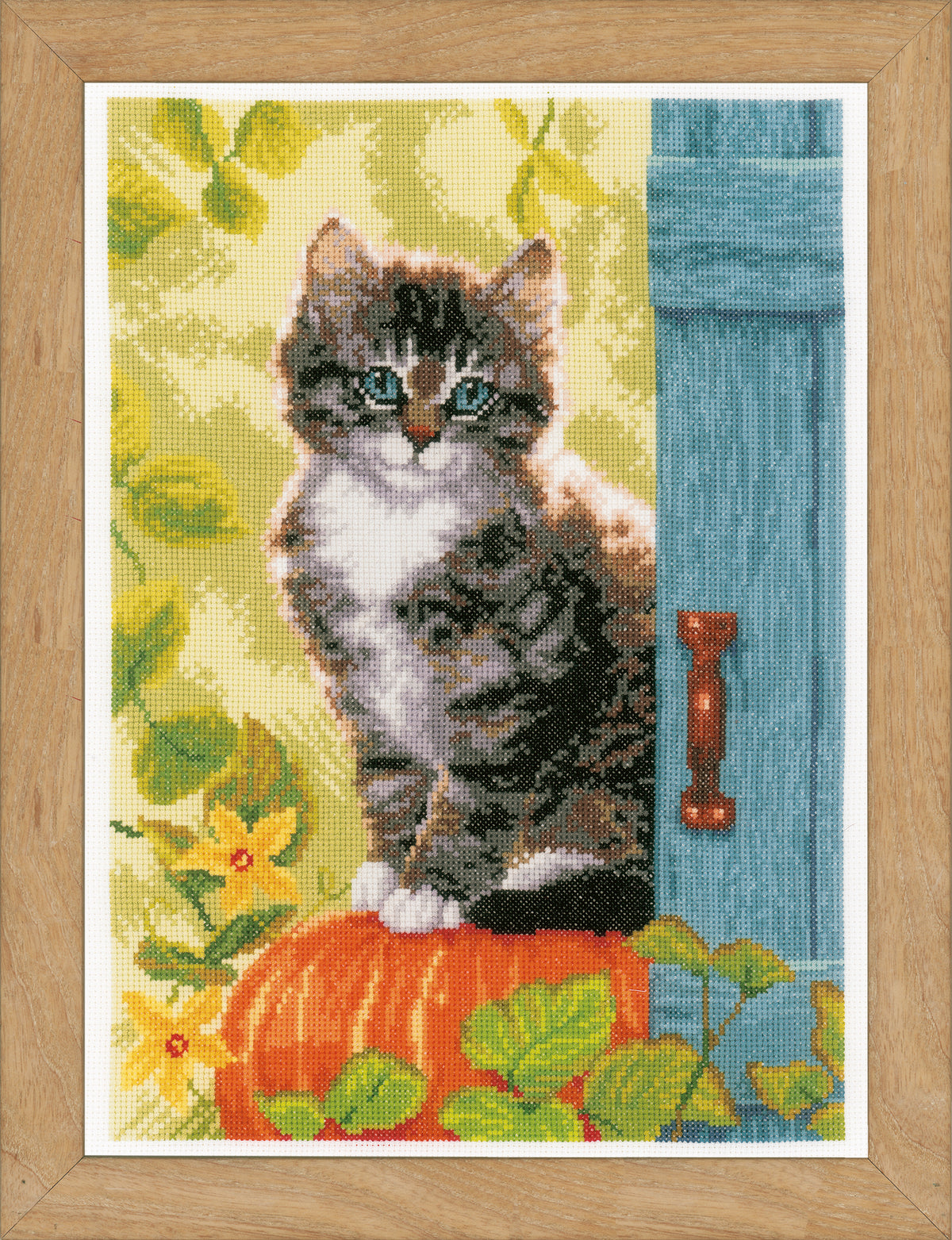Cross stitch picture of a cat with a pumpkin