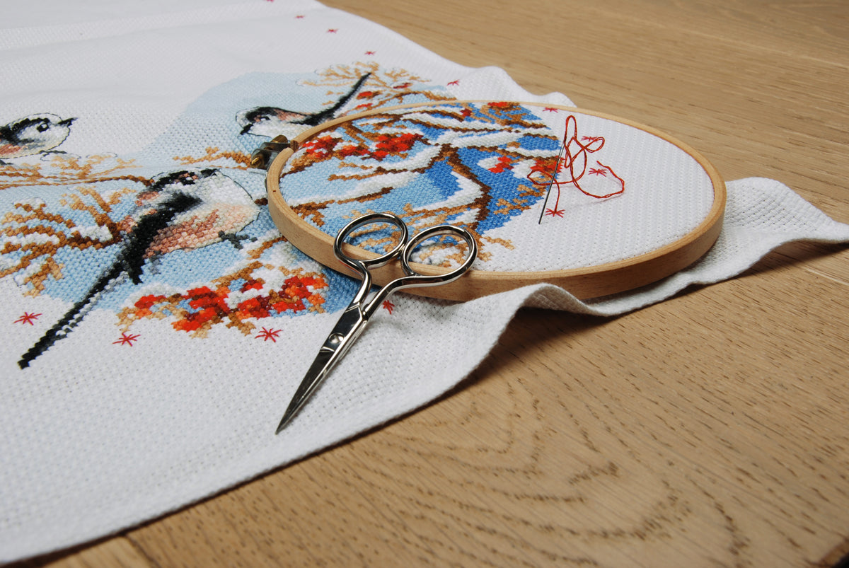 Cross stitch table runner with long-tailed tits and red berries