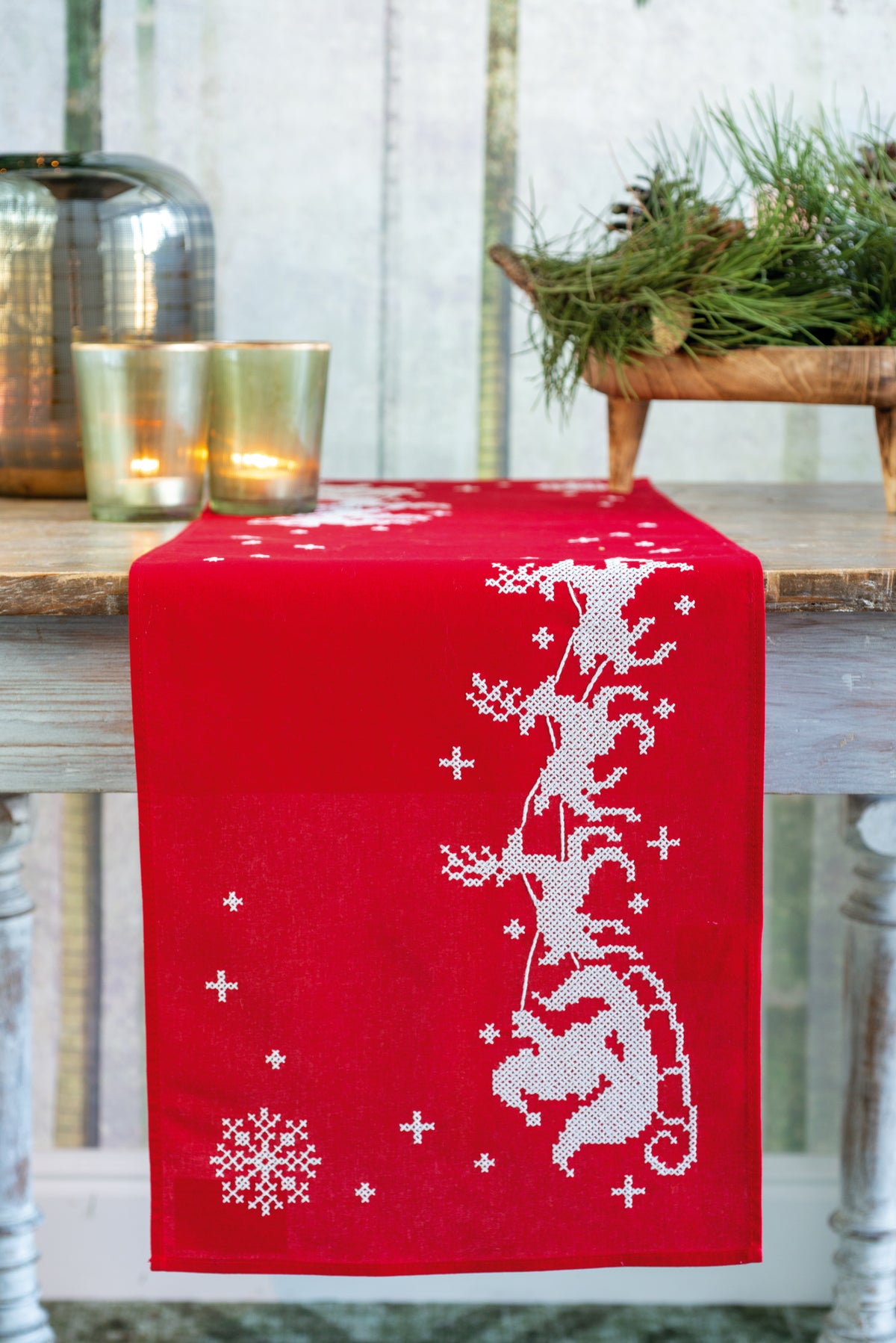 Red embroidered table runner with a sleigh design