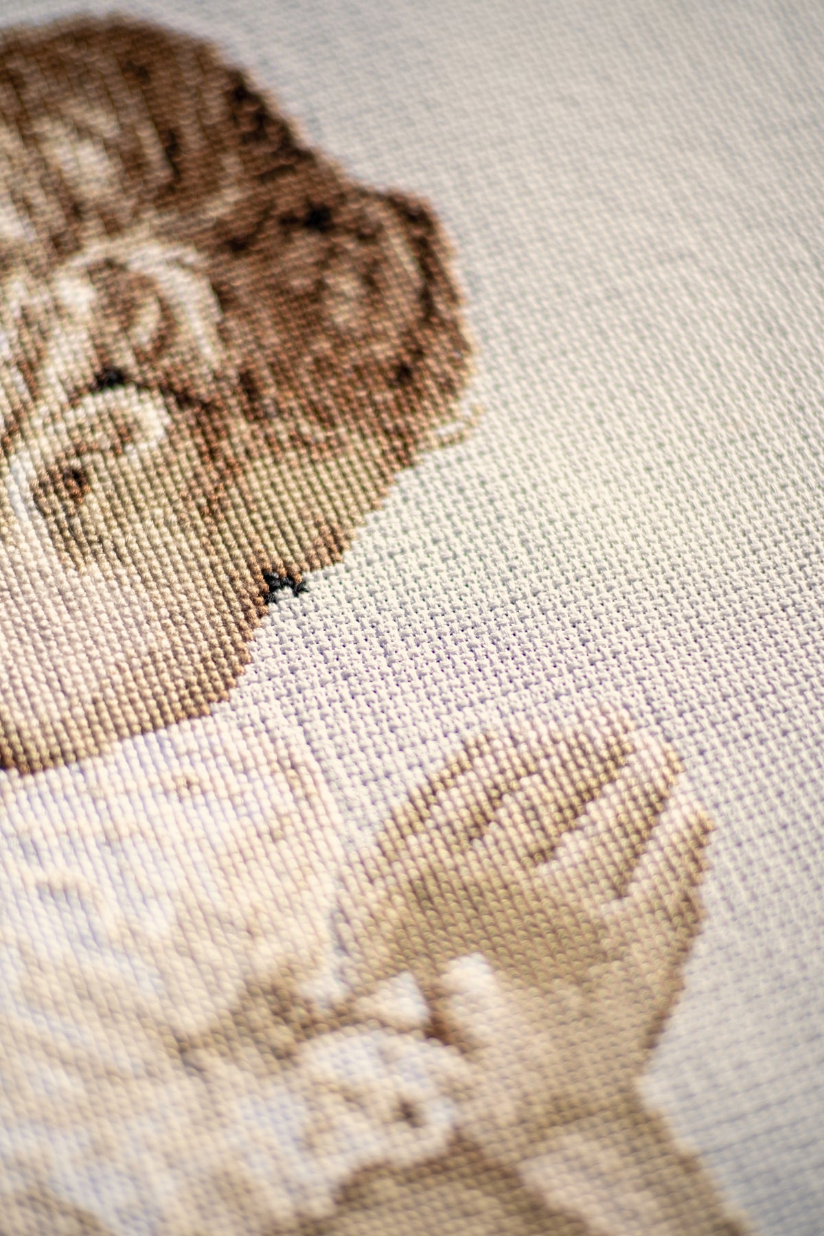 Cross stitch picture of a praying girl