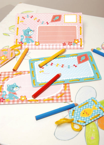 Children's stitched invitation cards and tags with a kitten design