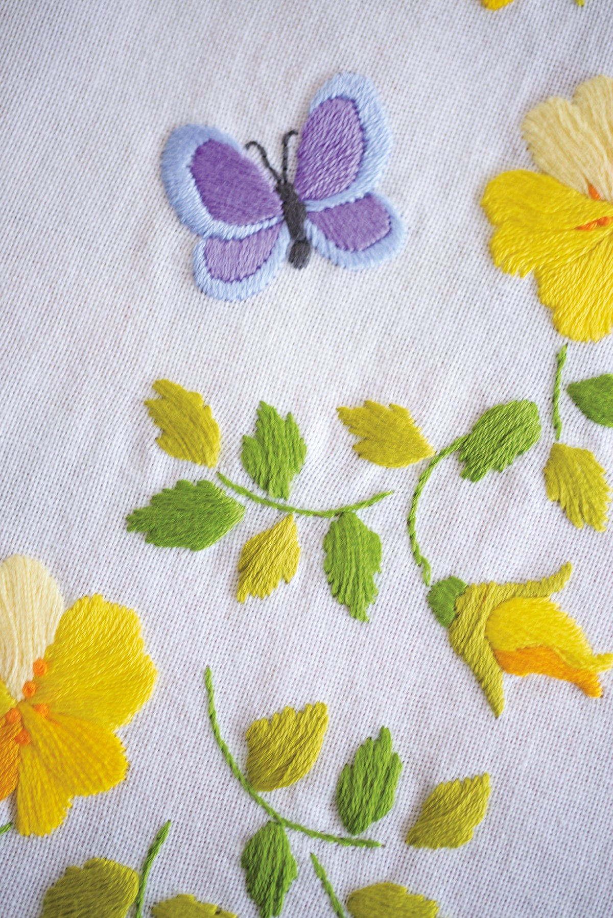 Embroidered white tablecloth with spring flowers