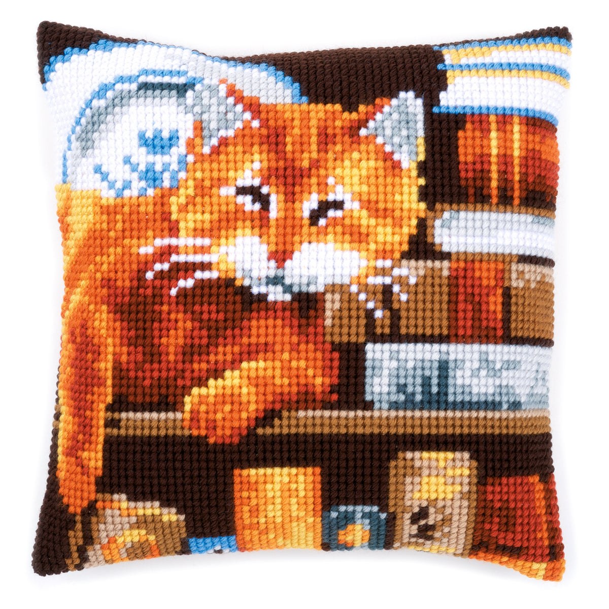 Finished cross stitch cushion with a cat and books