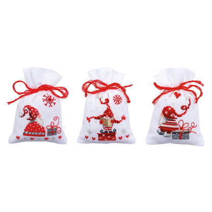 Three small aida gift bags cross stitched with gnomes