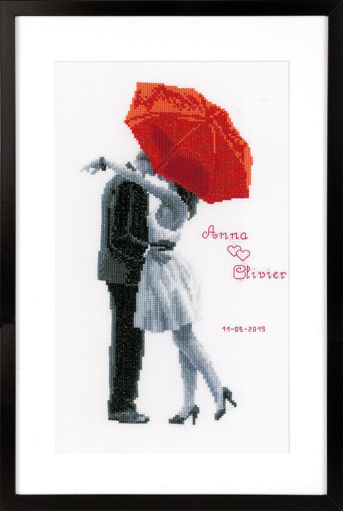 Cross stitch picture with a red umbrella