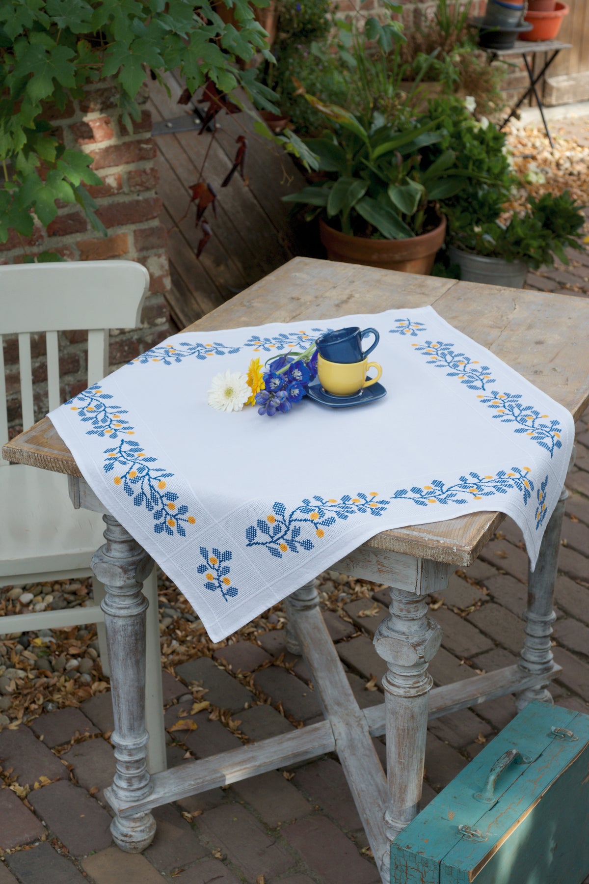White tablecloth with a blue cross stitched twig border